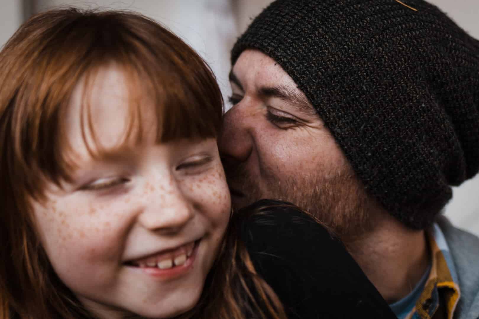 child and father laughing together