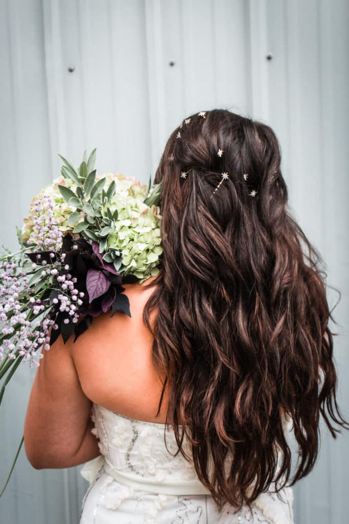 back of bride's long hair and wedding bouquet