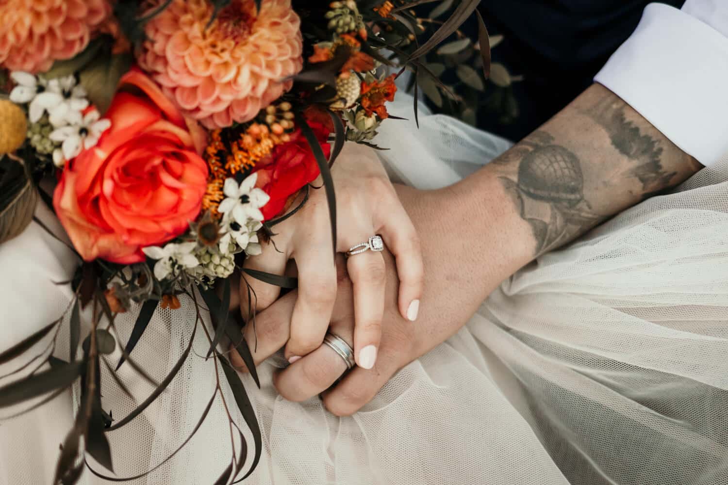bride and groom holding hands with wedding bouquet